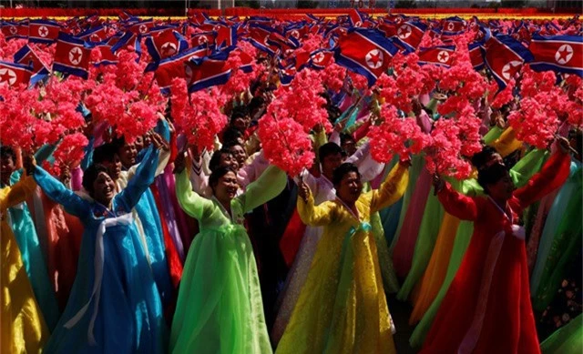 Không chỉ các binh sĩ tham gia lễ duyệt binh, lực lượng dân sự đại diện cho các nhóm ngành nghề khác nhau cũng cầm cờ, hoa, biểu ngữ diễu hành tại quảng trường Kim Nhật Thành. (Ảnh: Reuters)
