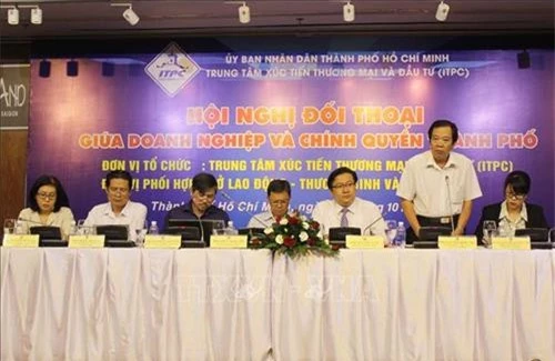 Lãnh đạo Sở Lao động Thương binh và Xã hội thành phố Hồ Chí Minh giải đáp vướng mắc cho doanh nghiệp. (Ảnh: TTXVN)