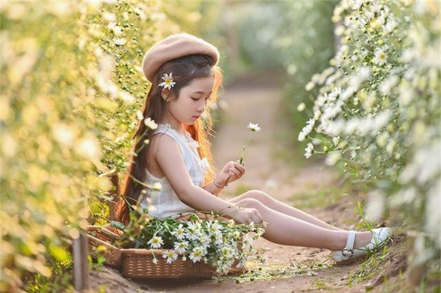 Cô bé giống như một thiên thần trong vườn cúc hoạ mi.