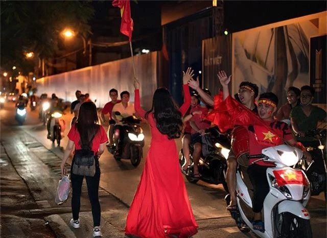 Hồng Hoa đập tay với các cổ động viên trên đường đi bảo ăn mừng chiến thắng.
