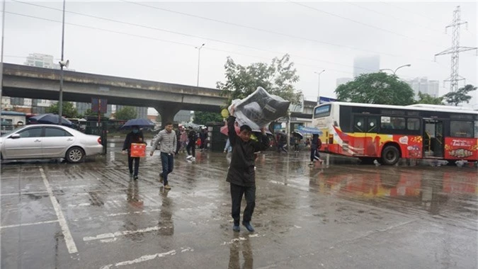 Người dân đổ ra bến xe về nghỉ Tết, đường phố Hà Nội ùn tắc trong mưa - Ảnh 4.