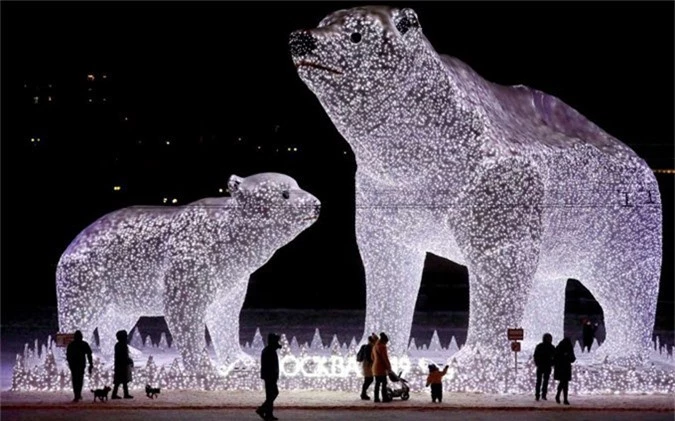 Moscow, Russia People walk near huge light sculptures of polar bears installed as part of decoration for the New Year and Christmas holidays in one of districts of Moscow, Russia, on Dec. 28.