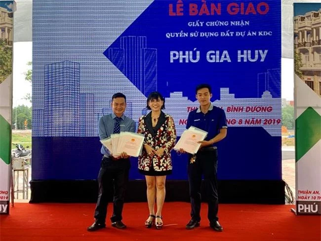 Bà Phạm Thị Hường (giữa), Chủ tịch HĐTV Công ty TNHH Bất động sản Phú Hồng Thịnh, trao sổ đỏ cho 329 khách hàng dự án Phú Gia Huy (ảnh PHT)