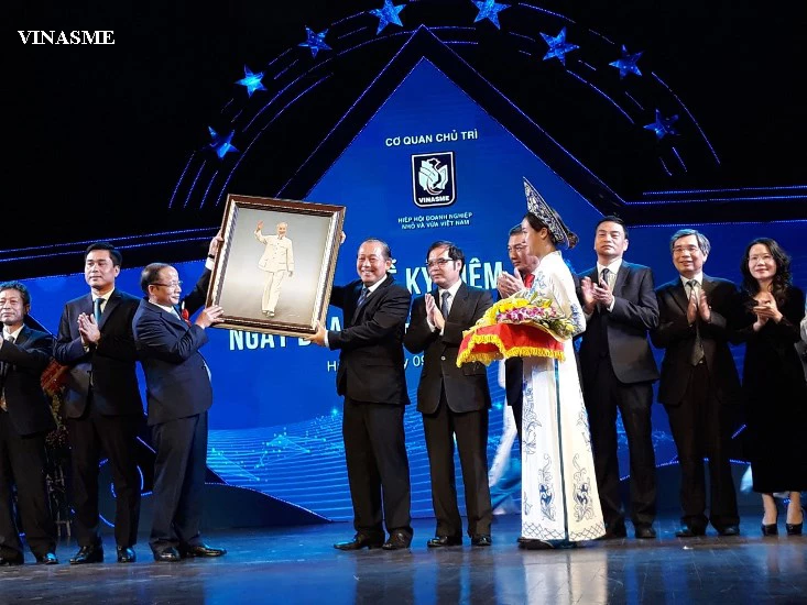 The Standing Committee of Vietnam Small and Medium Business Association receives gifts and flowers from Standing Deputy Prime Minister Truong Hoa Binh. (Photo: Thế Hiển).