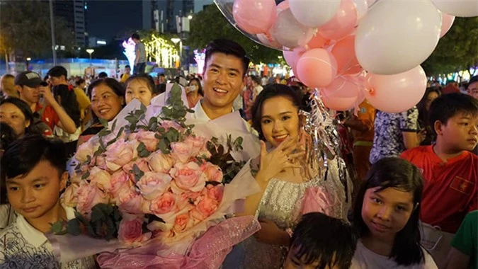 Các fan vây quanh Duy Mạnh và Quỳnh Anh sau màn cầu hôn trên phố đi bộ Nguyễn Huệ, TP HCM. Ảnh: ĐDM.