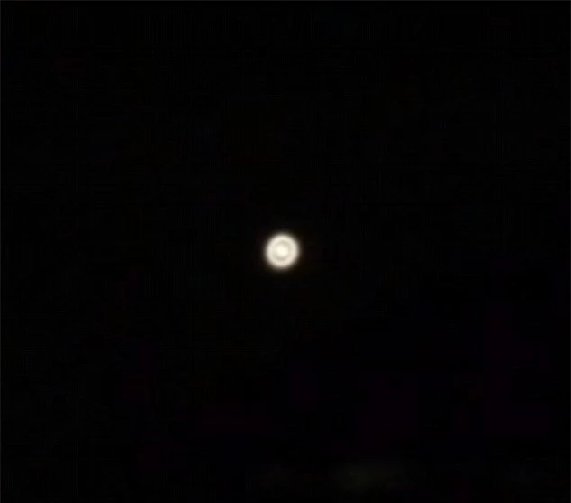 Mysterious: This strange light was seen hovering in the sky above Eltham in South London on Monday night