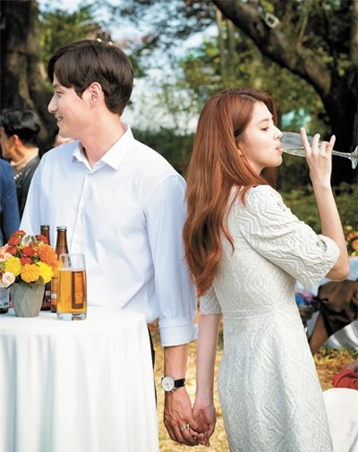 Người chồng Tae Oh của Sun Woo bí mật nắm tay người tình Dae Kyung trong bữa tiệc sinh nhật của anh (Ảnh: JTBC).