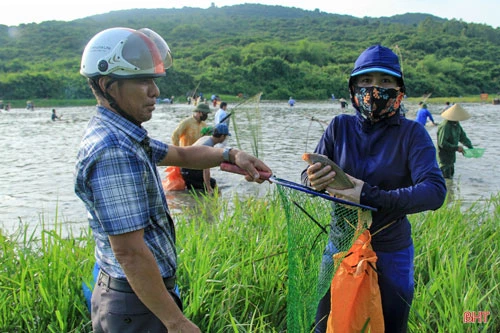 Một người dân bày tỏ niềm vui khi bắt được cá...