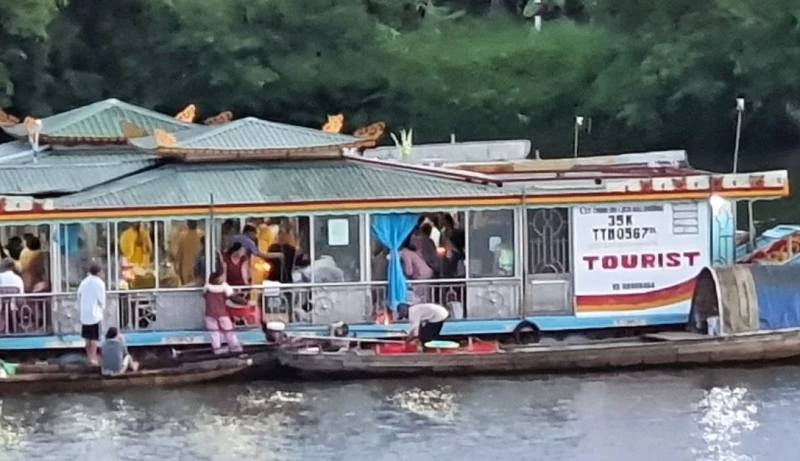 Cảnh 2 thuyền rồng rải vàng mã trên sông Hương được người dân ghi lại phản ánh trên Hue-S. Ảnh cắt từ clip