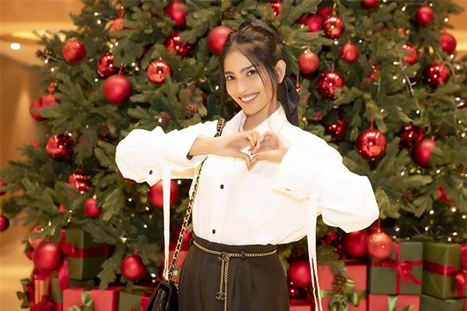 Á hậu các dân tộc Việt Nam 2007 trông trẻ trung, rạng rỡ khi mặc kín đáo, thanh lịch. Cô hào hứng chụp ảnh với cây thông Noel rực rỡ trang trí tại một khách sạn.