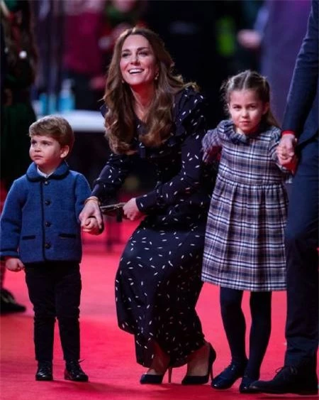 Little Louis, two, smartly dressed in blue cardigan was with his mother, the Duchess of Cambridge, elegant in a Alessandra Rich dress while Charlotte wore a grey and black tartan dress