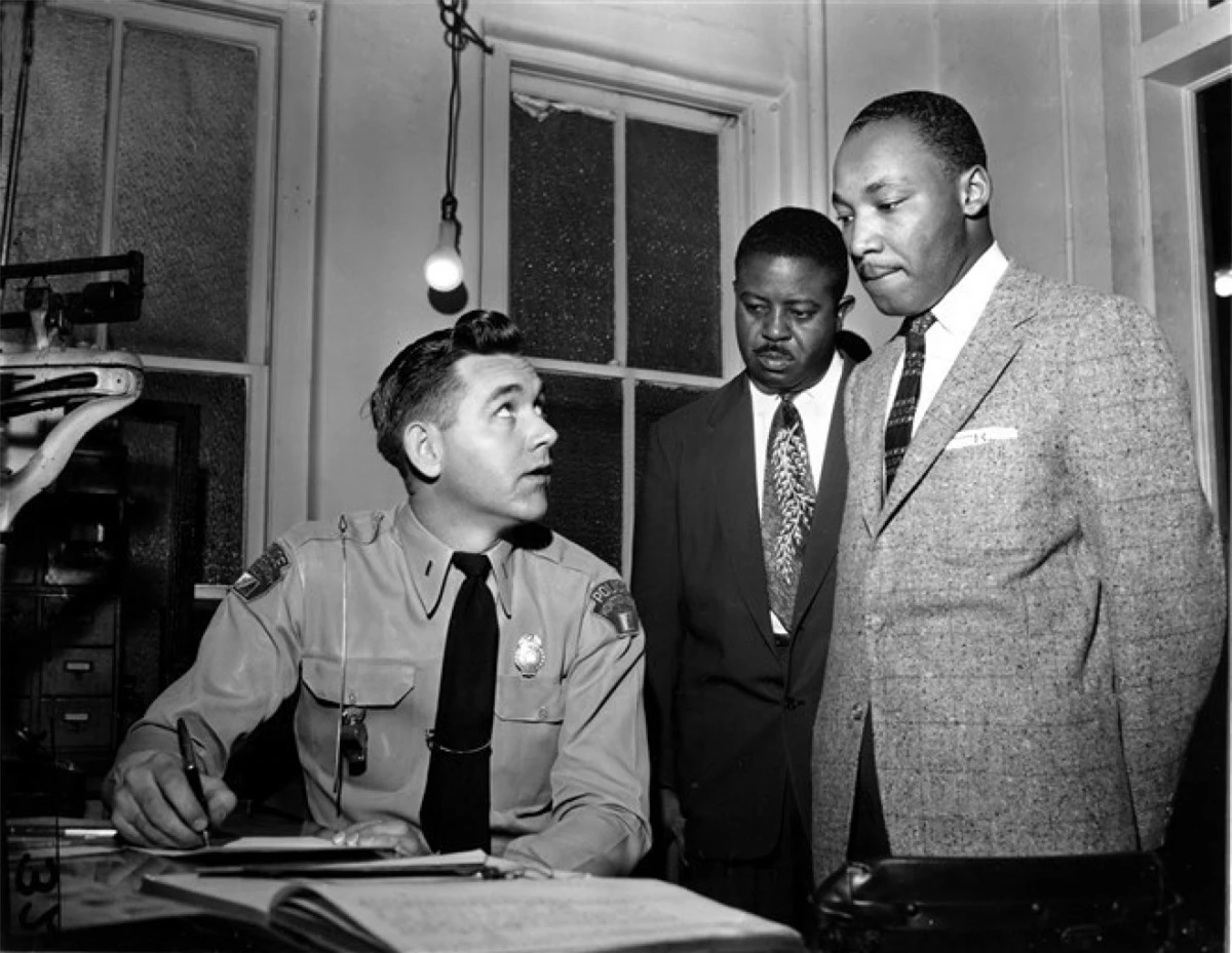 Mục sư King cùng với mục sư Ralph D. Abernathy (giữa) tại Montgomery ngày 23/2/1956. Các nhà hoạt động nhân quyền đã bị bắt vì khởi xướng phong trào tẩy chay xe buýt trong thành phố.Hoạt động này nhằm phản đối việc cảnh sát bắt phạt một phụ nữ da đen do bà không nhường chỗ cho hành khách da trắng. Ảnh: AP