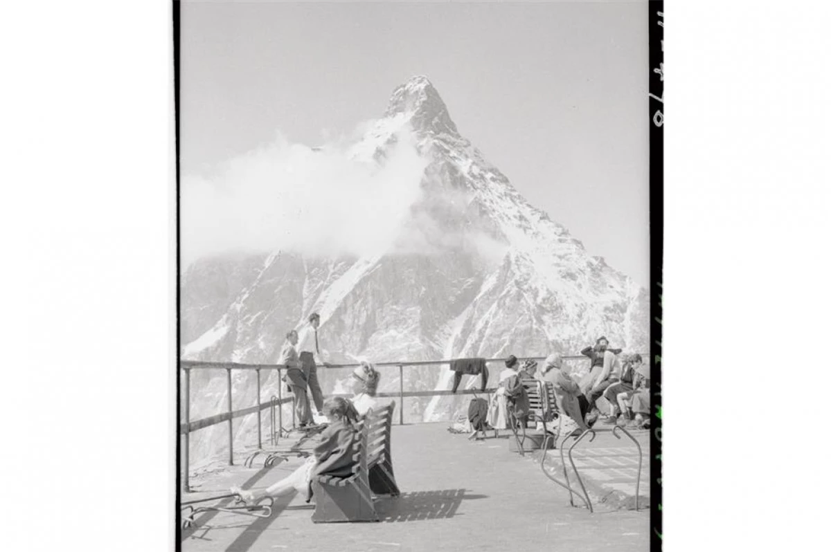 Núi Matterhorn (thuộc dãy Alps của Thụy Sĩ).Trong bức ảnh là khách du lịch nghỉ chân trên một điểm quan sát trên sườn núi phía Italy vào những năm 1950.