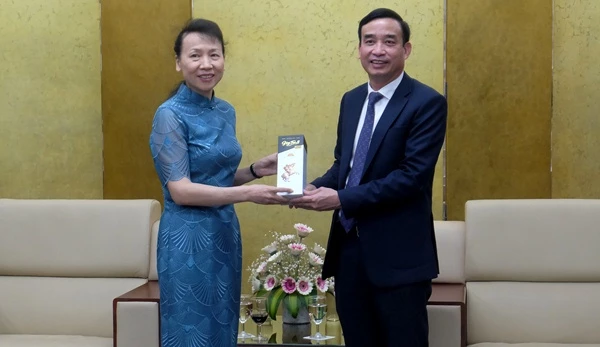 Chủ tịch UBND thành phố Lê Trung Chinh trao quà lưu niệm cho bà Đổng Bích Du