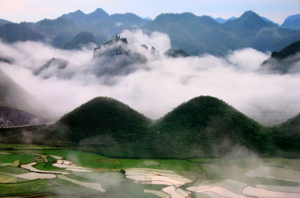 Núi Đôi gắn với những câu chuyện truyền thuyết được đồng bào các dân tộc nơi đây lưu truyền từ đời này sang đời khác. Trong đó, có câu chuyện rất cảm động kể rằng xưa kia, ở vùng đất này có một chàng trai người H’mông tuấn tú, có tài thổi đàn môi. Tiếng đàn môi của chàng réo rắt như tiếng suối, ríu rít lảnh lót như tiếng chim rừng, lúc sâu lắng, trầm bổng, da diết như tiếng gió giữa đêm khuya, bay cao, bay xa mãi. Có một nàng tiên trên thượng giới tên Hoa Đào tình cờ nghe được tiếng đàn môi của chàng, đã theo gió trốn xuống trần gian đi tìm. Phải lòng chàng, nàng tìm cách ở lại vùng đất này. Họ nên vợ nên chồng và sinh được một bé trai kháu khỉnh. Núi đôi Quản Bạ đã được Bộ Văn hoá, Thể thao và Du lịch công nhận là Danh thắng cấp quốc gia vào năm 2010. Ảnh: Dulichhagiang.vn.