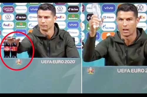 Ronaldo bỏ 2 chai Coca-Cola ra khỏi bàn họp báo.