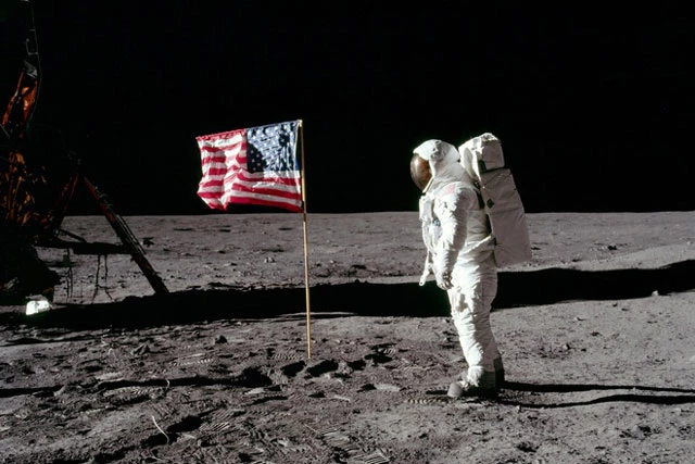Sáng 20/7/1969, Neil Armstrong trở thành người đầu tiên đặt chân xuống Mặt Trăng. Tại đây, ông nói câu bất hủ: “Đây là bước đi nhỏ của một con người nhưng là bước tiến lớn của nhân loại". Sau đó Neil Armstrong và bạn đồng hành Buzz Aldrin cùng căng lá quốc kỳ Mỹ trên Mặt Trăng.