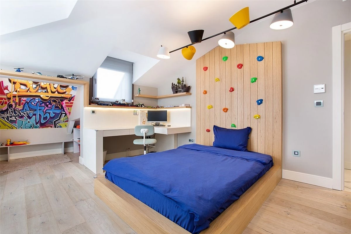 
Phòng ngủ dành cho bọn trẻ vô cùng hiện đại với những gam màu trung tính kết hợp cùng khu học tập nhỏ gọn, bức tường leo núi.