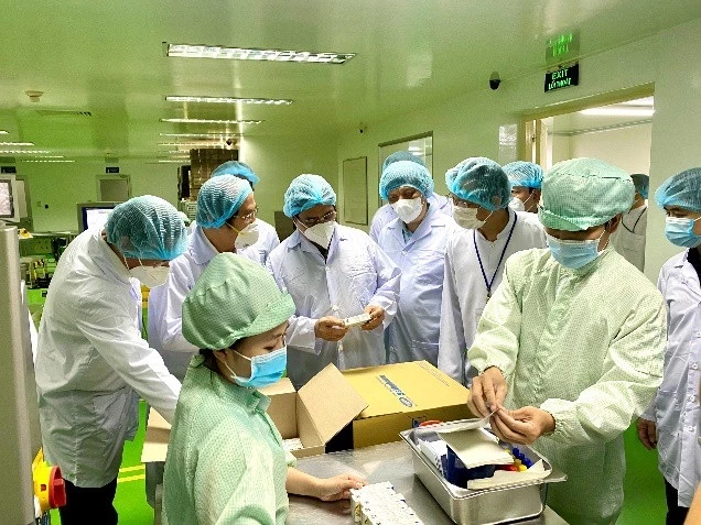 Thủ tướng Chính phủ và Bộ trưởng Y tế  thăm khu vực đóng gói tại Nhà máy sản xuất. TTƯT, DS. CKII Trần Tựu giới thiệu với Thủ tướng về dây chuyền đóng gói tự động.