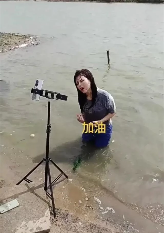 Lăn lê trong hồ nước cạn để livestream giả vờ đang ở vùng mưa lũ, nhóm truyền thông bất lương nhận đủ gạch đá từ cư dân mạng - Ảnh 2.