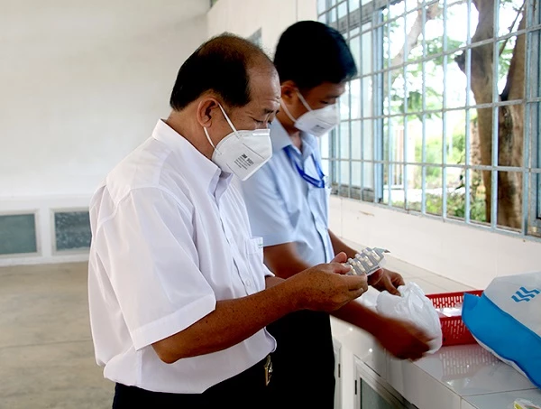 Phó Chủ tịch UBND tỉnh Đồng Tháp kiểm tra túi thuốc trước khi triển khai điều trị cho bệnh nhân COVID-19.