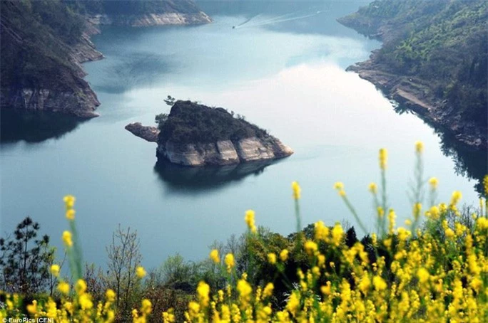 The island seen from afar. Know as the spring turtle rising from water, the rock in Muodaoxi River is a new tourist hot spot in southwest China