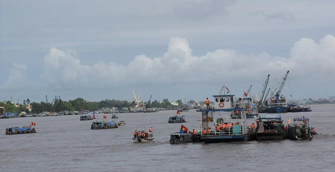 Các đoàn ghe tàu thực hiện việc thả cá xuống dòng sông Hậu.