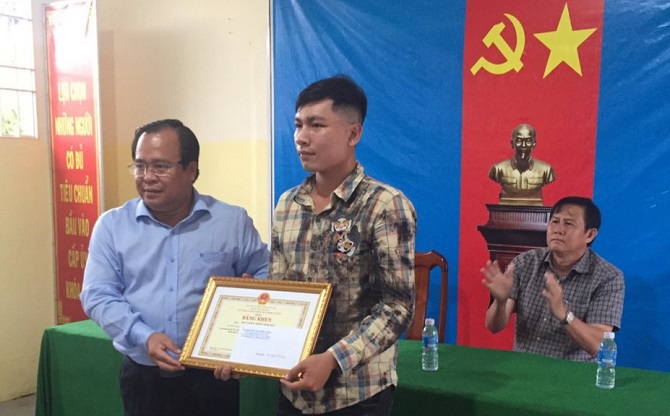 Ông Nguyễn Minh Luân trao bằng khen của Chủ tịch UBND tỉnh cho anh Nguyễn Hiền Phong