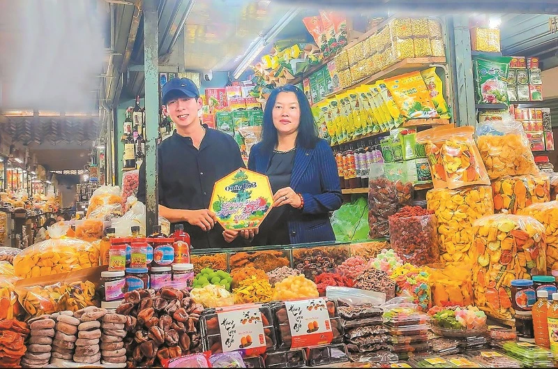 Bà Trần Thị Vũ Loan – Phó Chủ tịch UBND TP Đà Lạt, trao logo chứng nhận “Quầy hàng phong cách người Đà Lạt” cho tiểu thương ngành hàng đặc sản tại Chợ Đà Lạt.