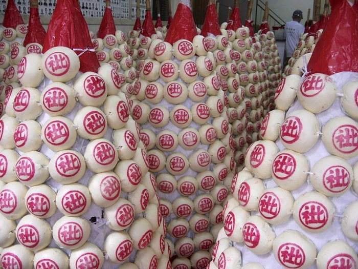 Lễ hội bánh bao Cheung Chau (Trung Quốc): Người tham gia leo lên tháp bánh bao để giành lấy chiếc bánh cao nhất, kỷ niệm ngày sinh của Đức Phật.