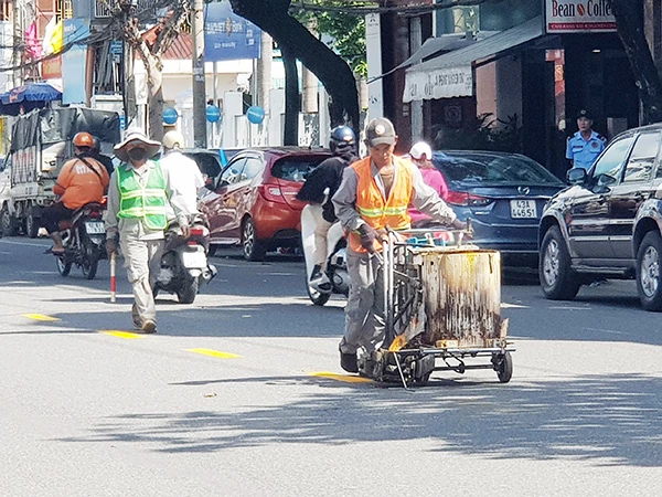 Sơn kẻ lại vạch giao thông trên các tuyến đường ở Đà Nẵng để chuẩn bị đón Tết Nguyên đán Giáp Thìn 2024.