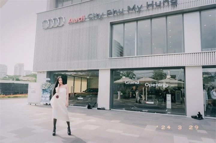 Á hậu 1 Miss Grand 2023 Bùi Khánh Linh thả dáng cá tính trong trang phục váy trắng và bốt cao cổ đen.