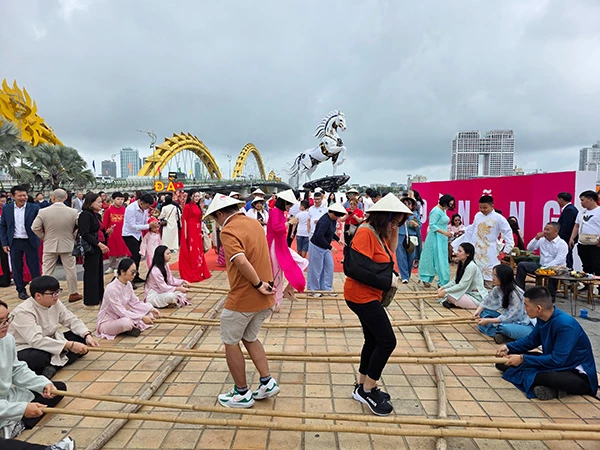 Du khách trải nghiệm trò chơi dân gian nhảy sạp của Việt Nam.