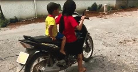 Clip: Bé gái chân chưa chạm đất lái xe máy chở em nhỏ lao vun vút trên đường